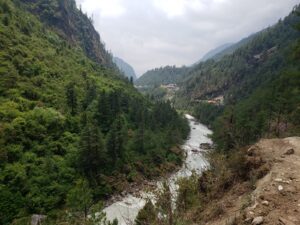 The Imja Khola River is crystal clear with bright blues and greens. At some points, there is a bit of white water.