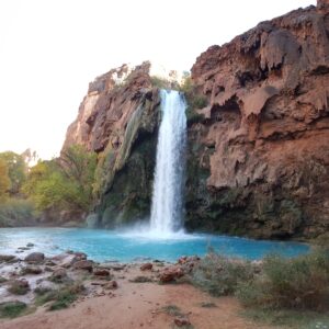 Backpacking to Havasu Falls - Havasu Falls rushes into a spectacular turquoise pool against a backdrop of red and pink canyon walls