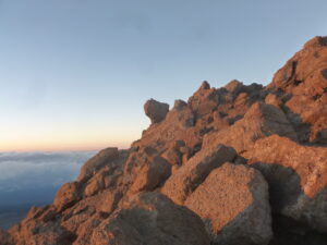 Summit Kilimanjaro, the Sun illuminates the clouds and mountains