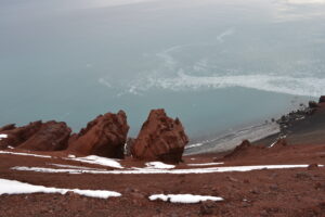 Deacon Peak is a cinder cone with volcanic red rock remnants. Antarctic Kayaking