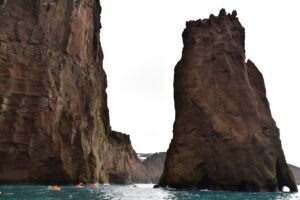There is a rocky formation named the Needle next to the entrance to the atoll, Deception Island, in the seas surrounding Antarctica. Antarctic Kayaking