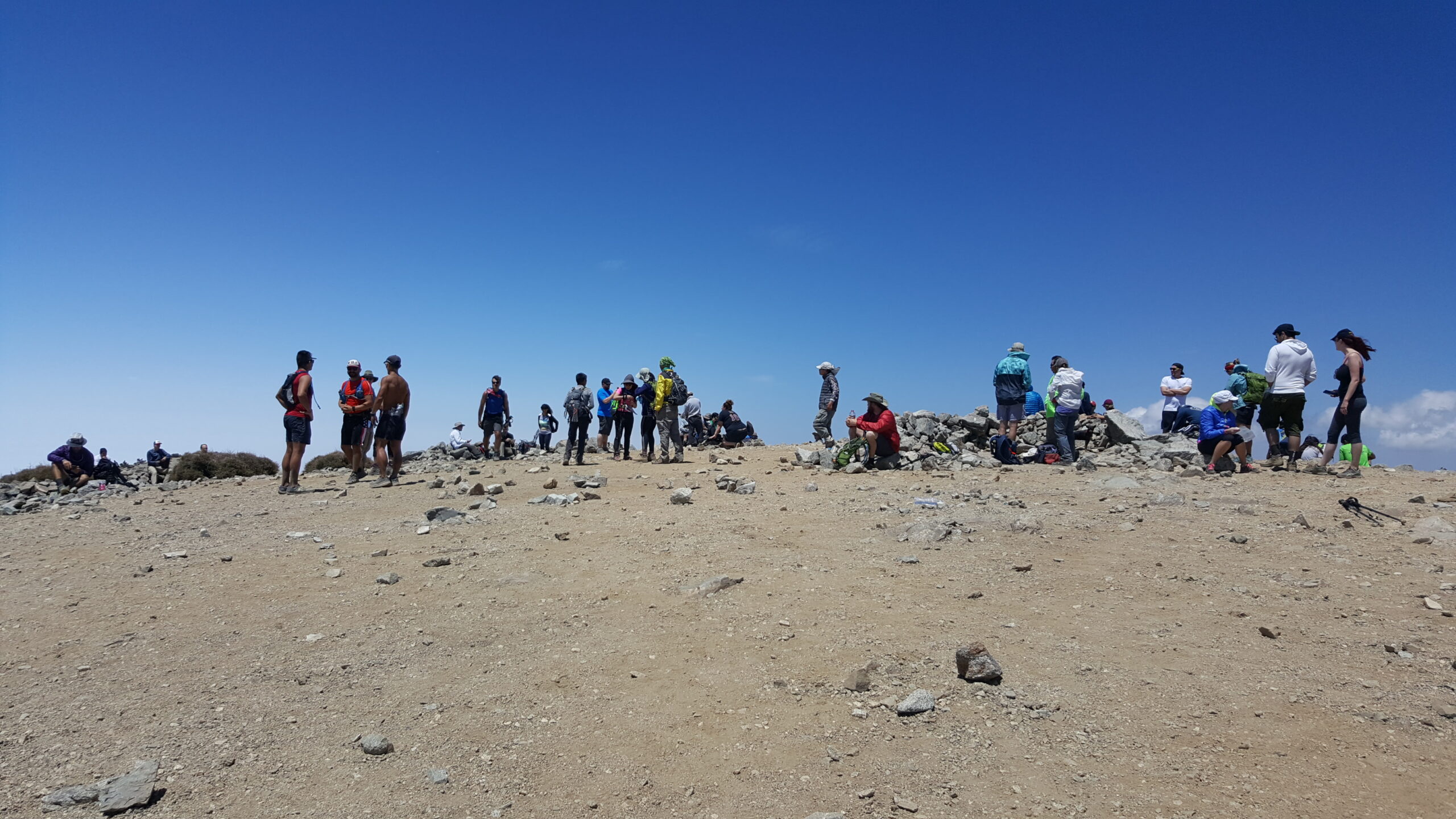 A crowd of people standing on top of Baldy | Mt. Baldy via Devil's Backbone