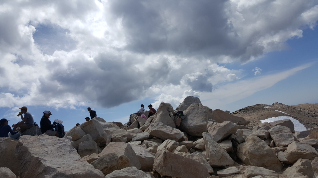 Summiteers sit on the giant rocks on top of San Gorgonio Mountain