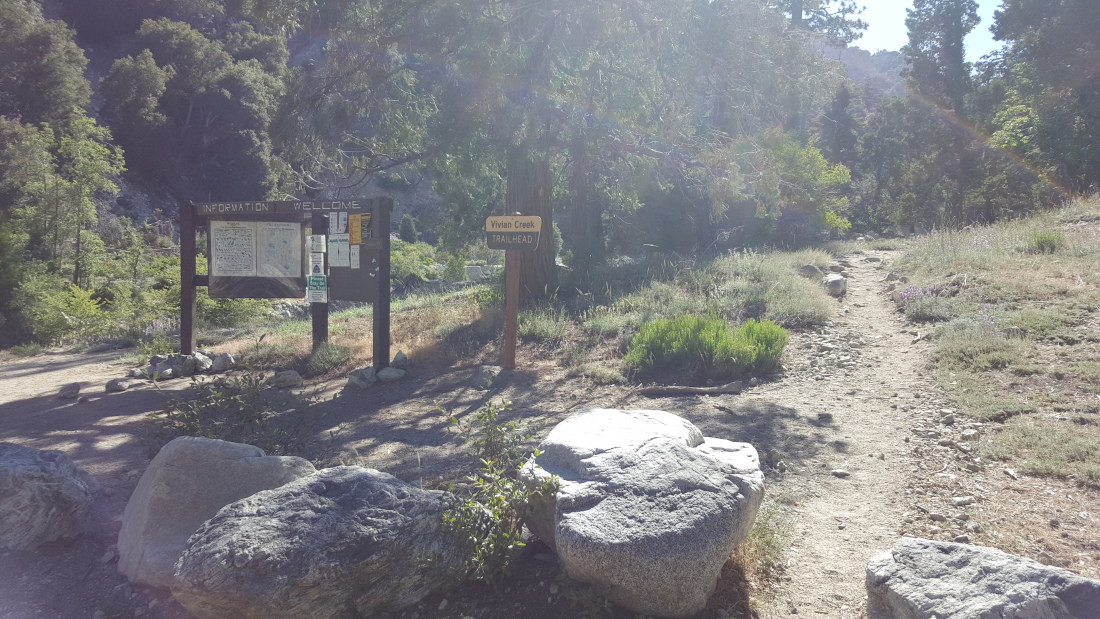 The trailhead sign, bulletin board, and the start of the trail