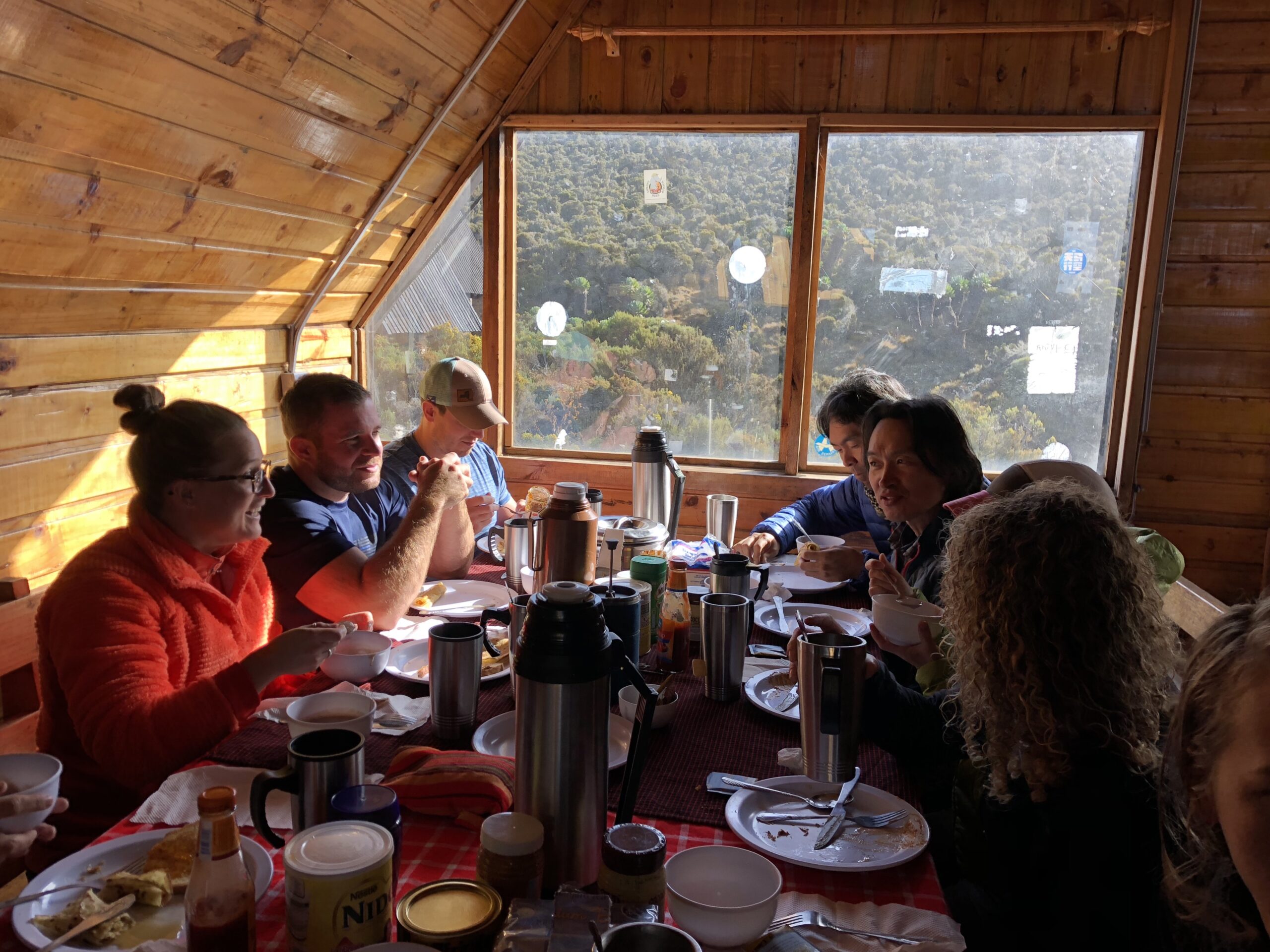 Team of hikers eating breakfast