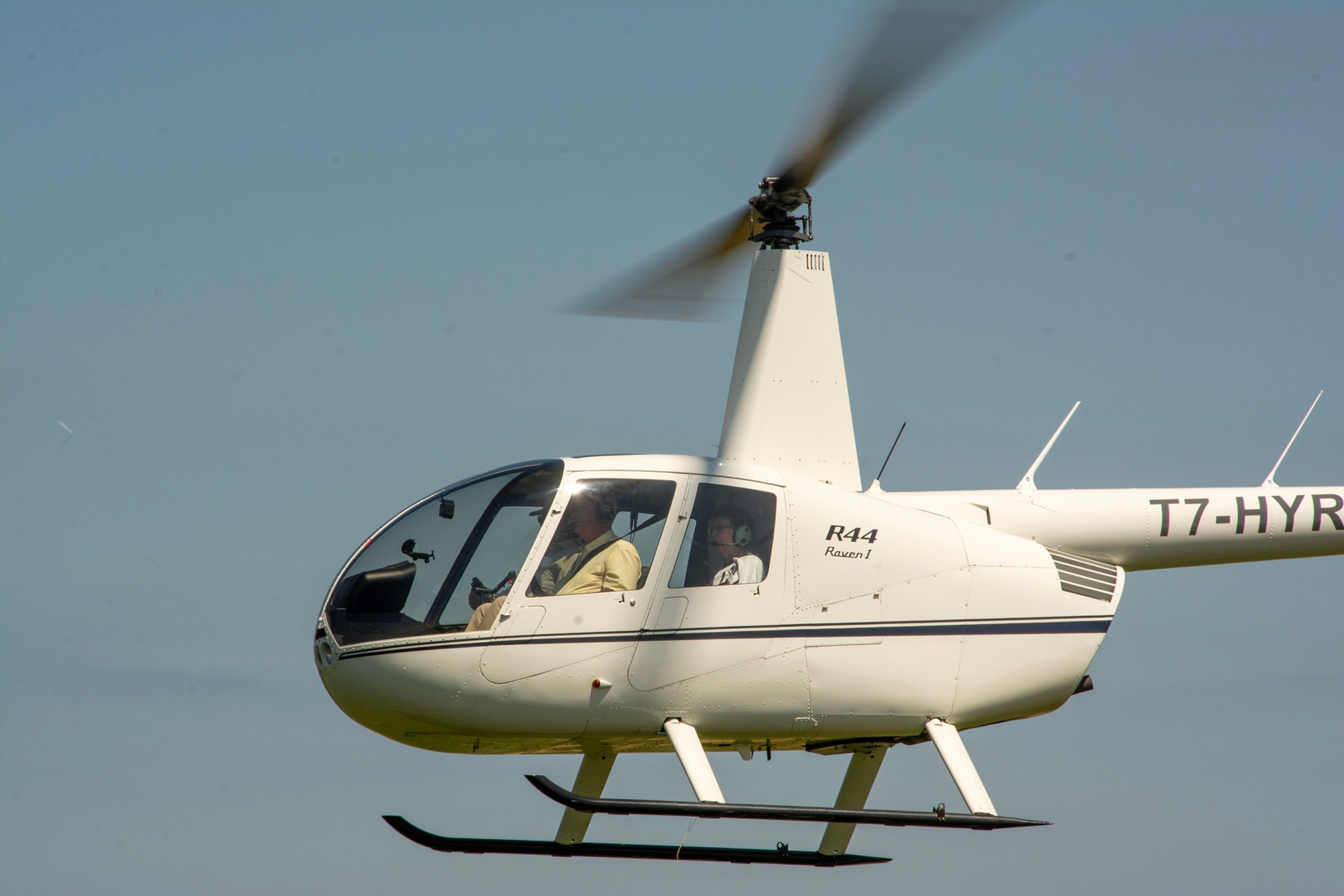 A R22 helicopter is in flight