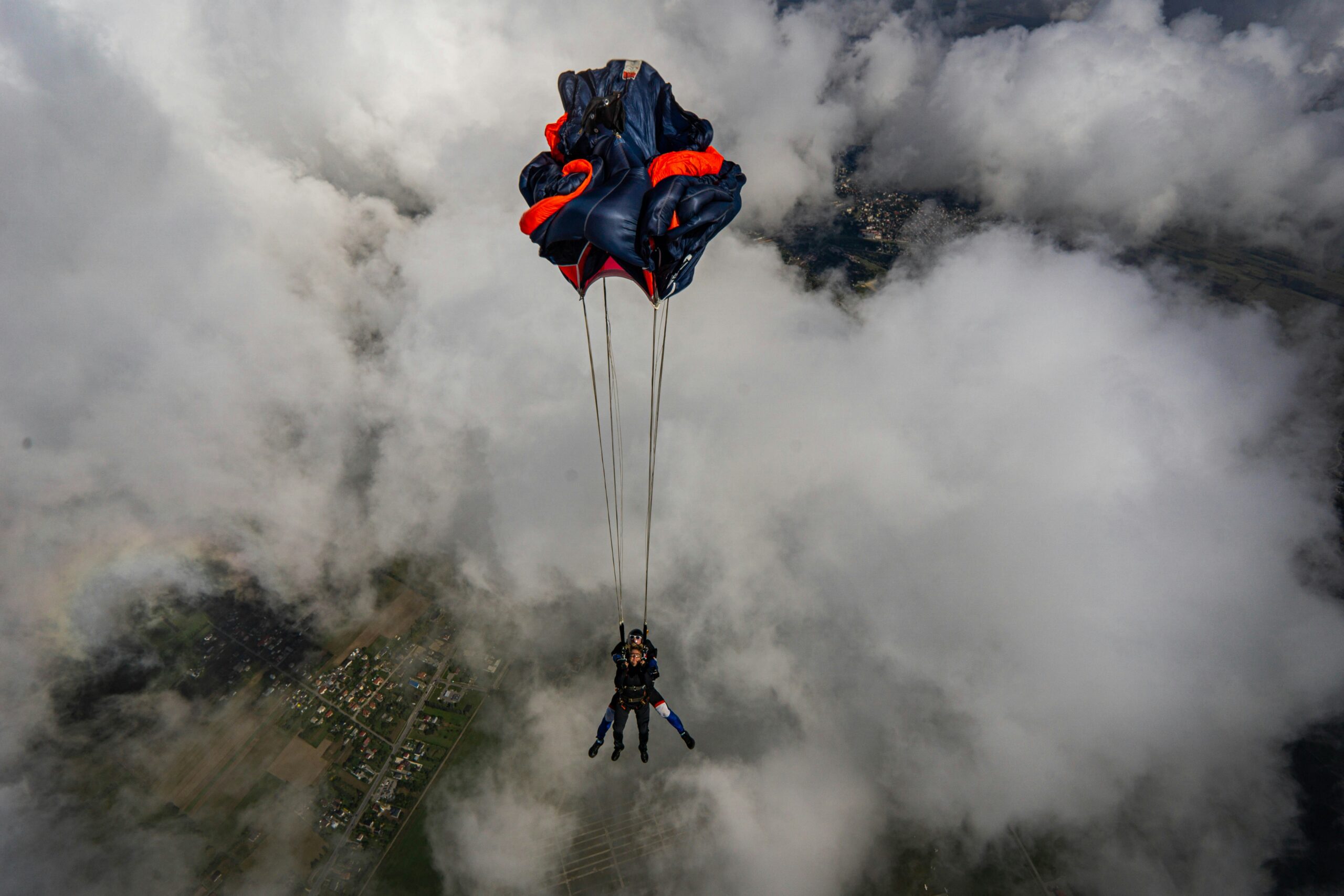 This is the moment the skydiver pulls the ripcord. The chute begins to open and has not filled with air yet.